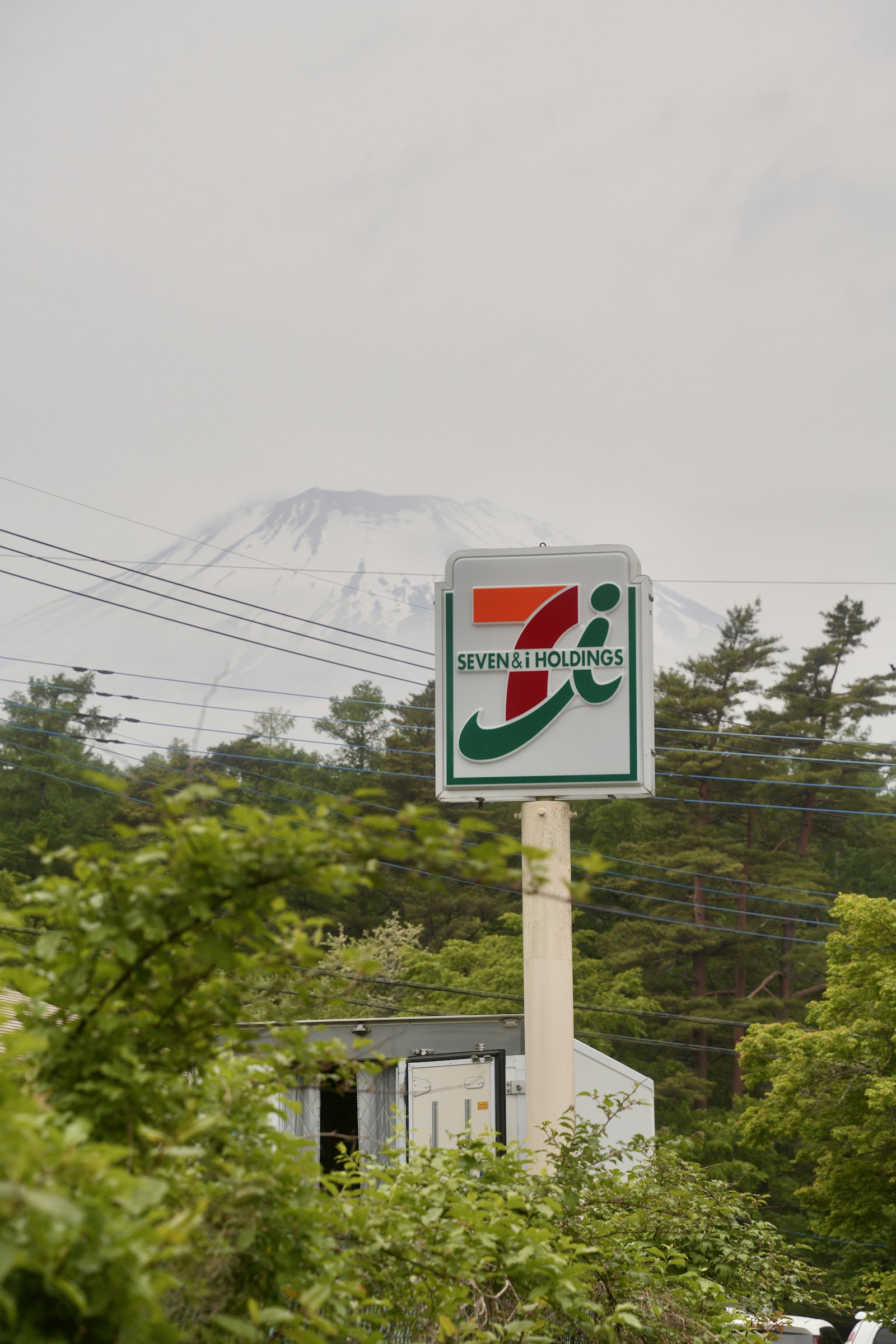 7-Eleven roadside sign with Mount Fuji in the background