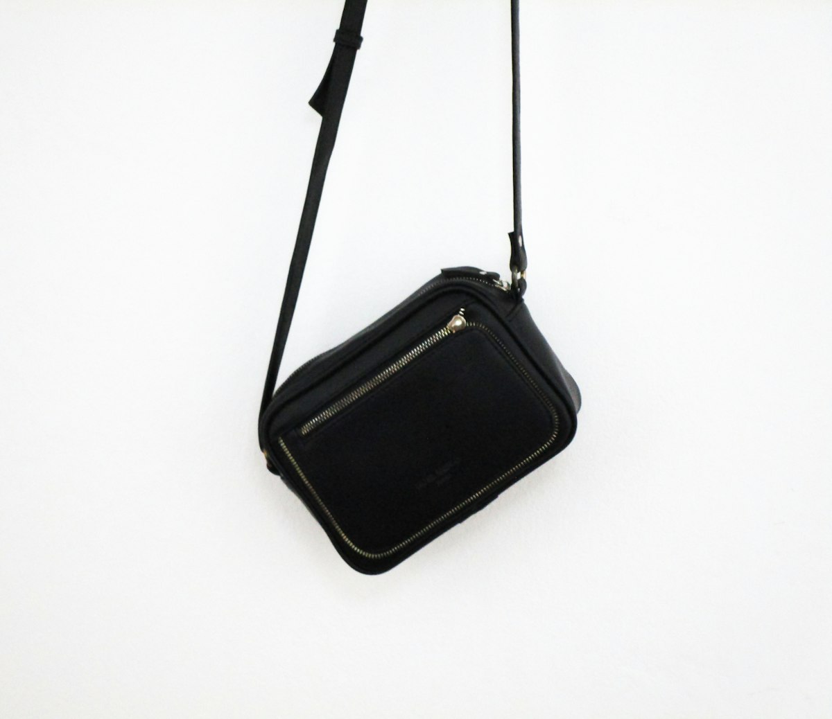 Small black crossbody bag on a white background