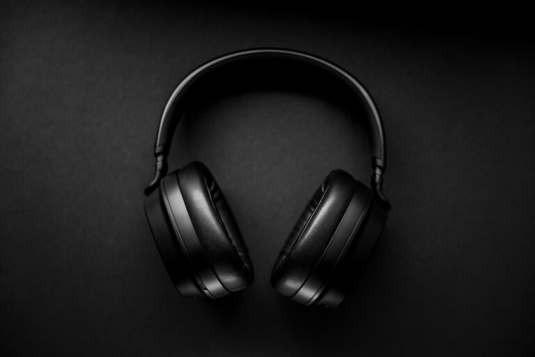 Black wireless over-ear headphones on a dark background