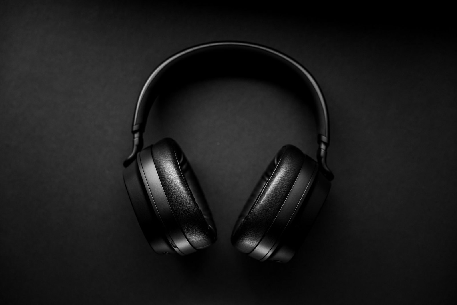 Black wireless over-ear headphones on a dark background