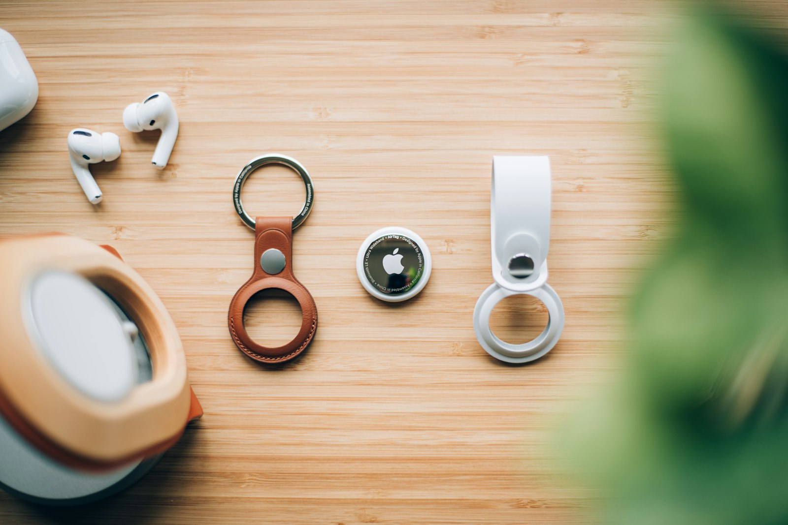 Bluetooth tracker tags and key rings laid out on a wooden table