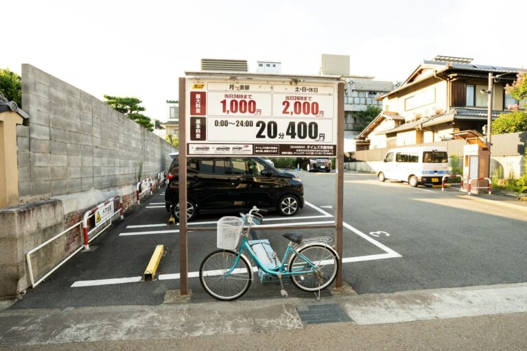 Small coin parking lot in Kyoto with a price sign