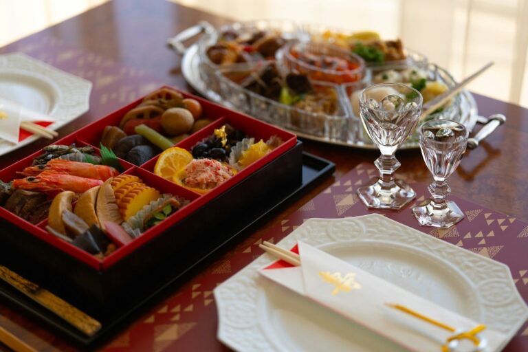 Colorful Japanese food arranged in a red lacquer bento-style box