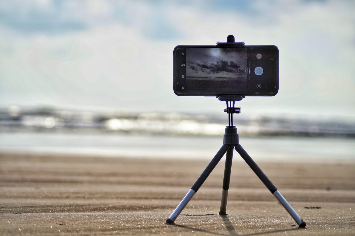 Smartphone mounted on a mini tripod outdoors