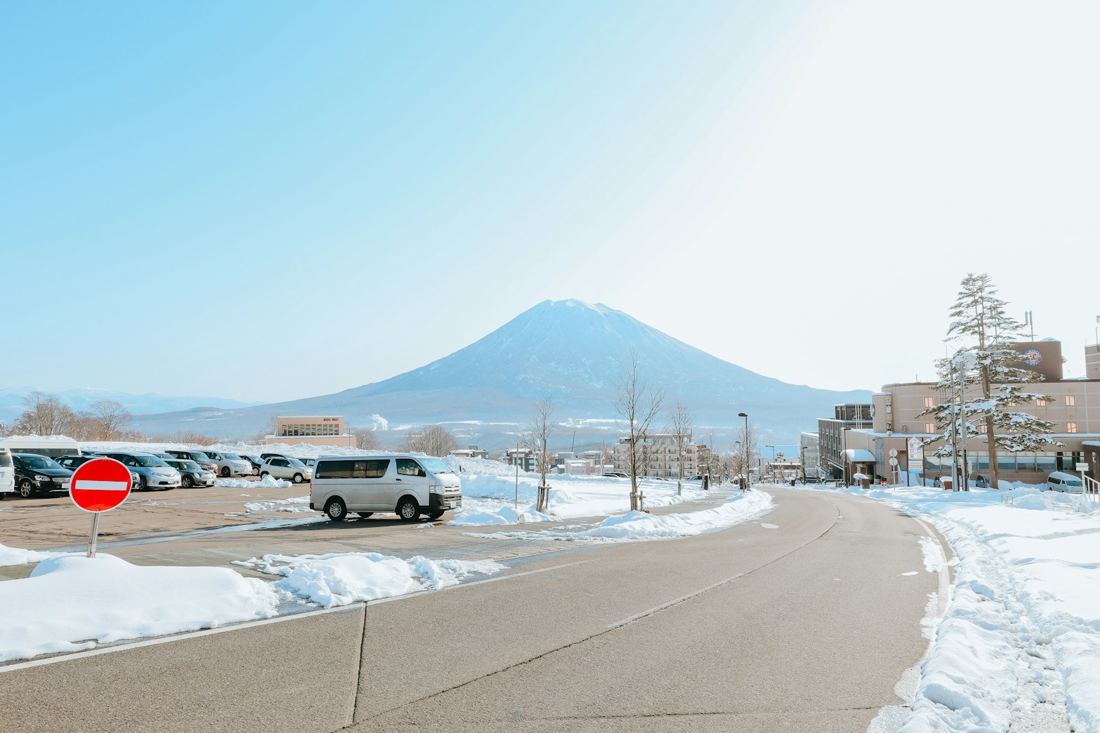 Car on a snowy road in Hokkaido with a mountain behind