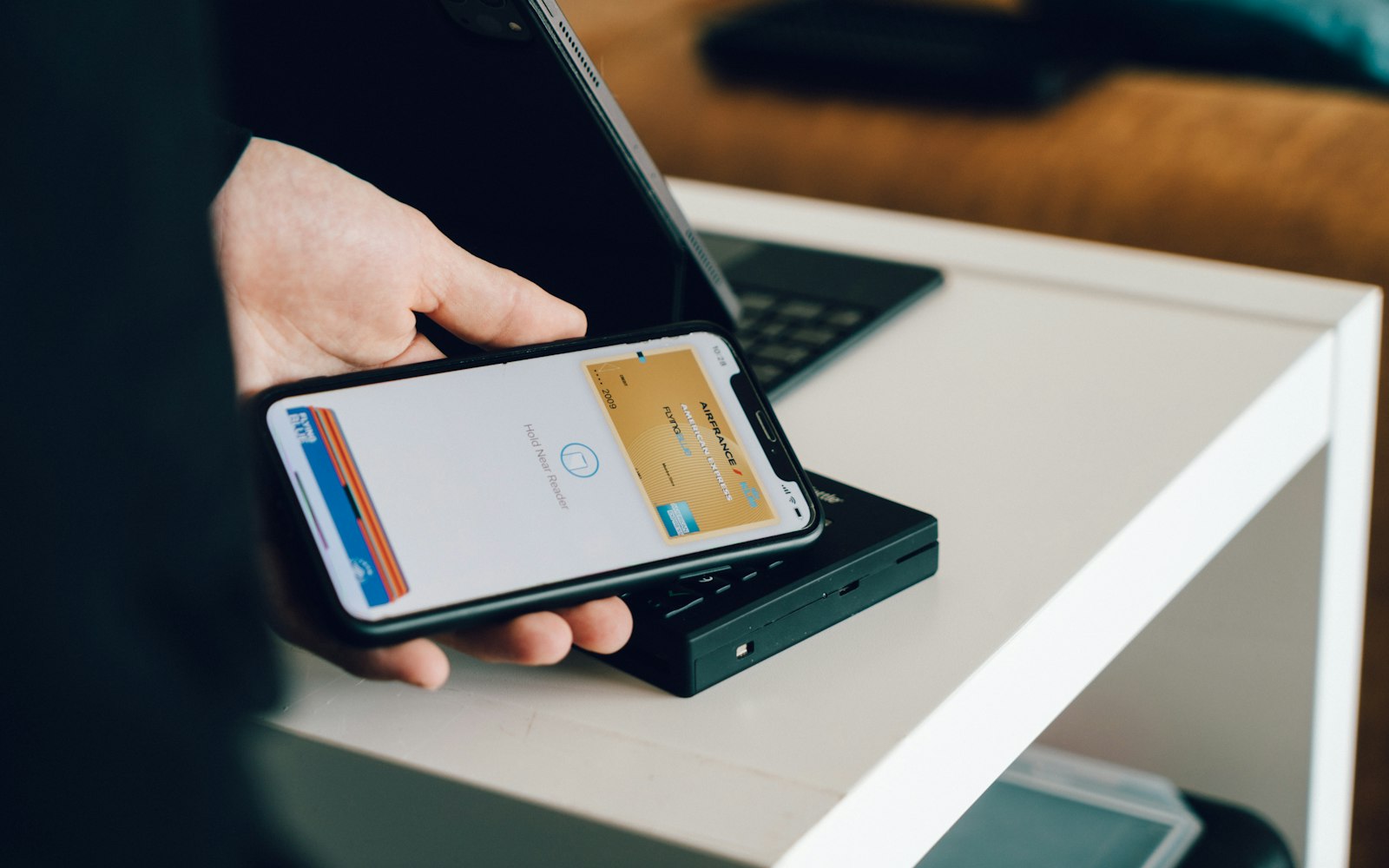 Paying by holding a smartphone over a contactless card reader