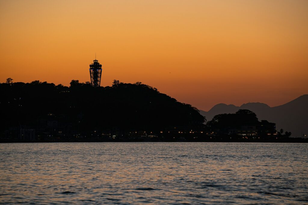 Silhouette of Enoshima island and its Sea Candle lighthouse at sunset