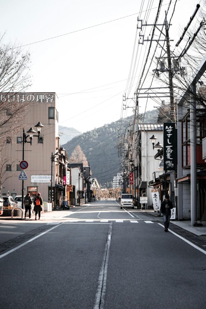 A street in Gero Onsen town with forested mountains behind