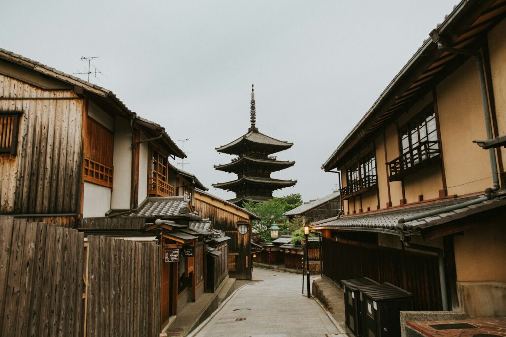 Traditional wooden houses on a sloping street below the Yasaka Pagoda in Higashiyama, Kyoto