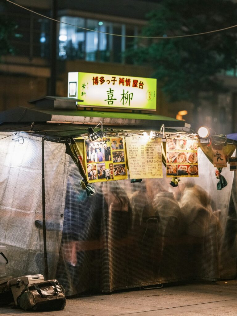 A lantern-lit yatai food stall at night in Tenjin, Fukuoka