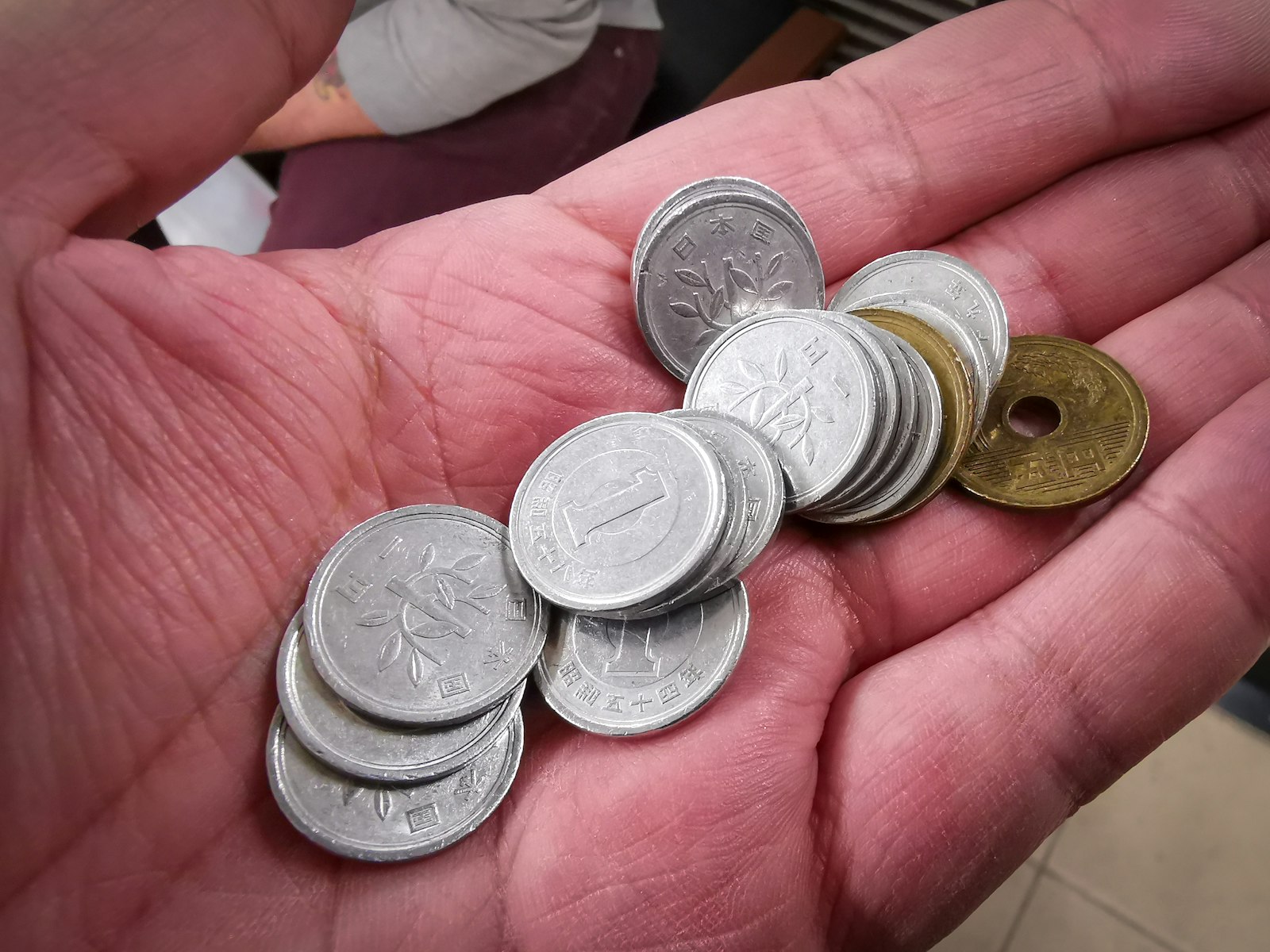 Handful of Japanese yen coins in an open palm