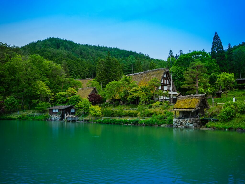 Gassho-zukuri farmhouses beside the pond at Hida Folk Village in Takayama