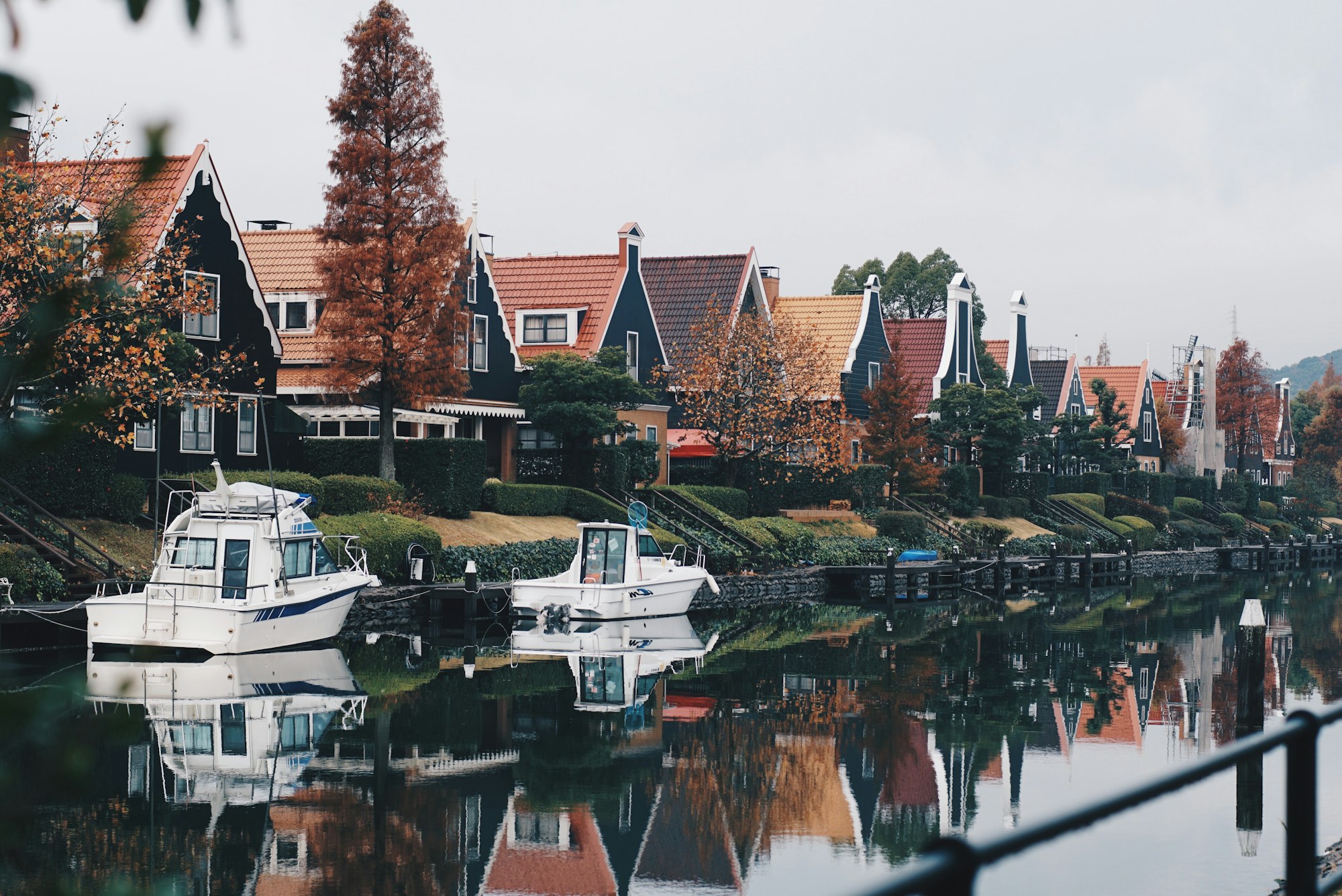 Dutch-style houses and boats along a canal at Huis Ten Bosch