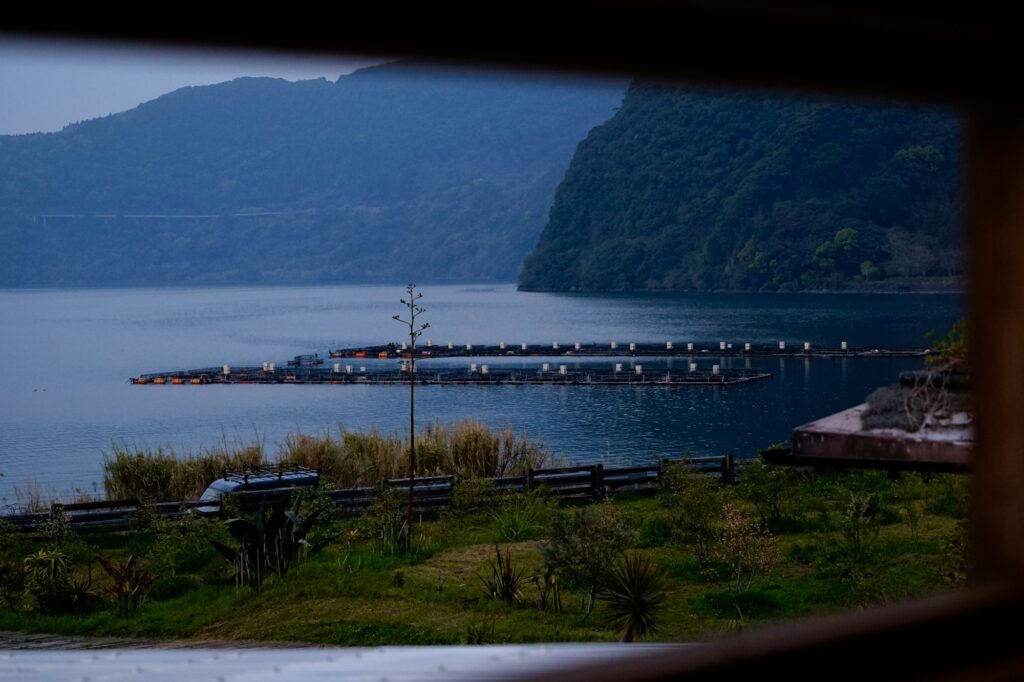 A calm lake framed by green hills in Ibusuki