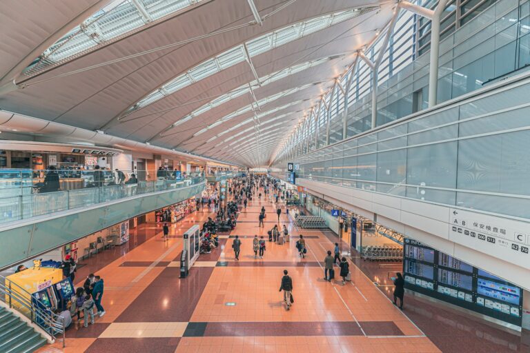 Travelers walking through a bright airport terminal in Japan