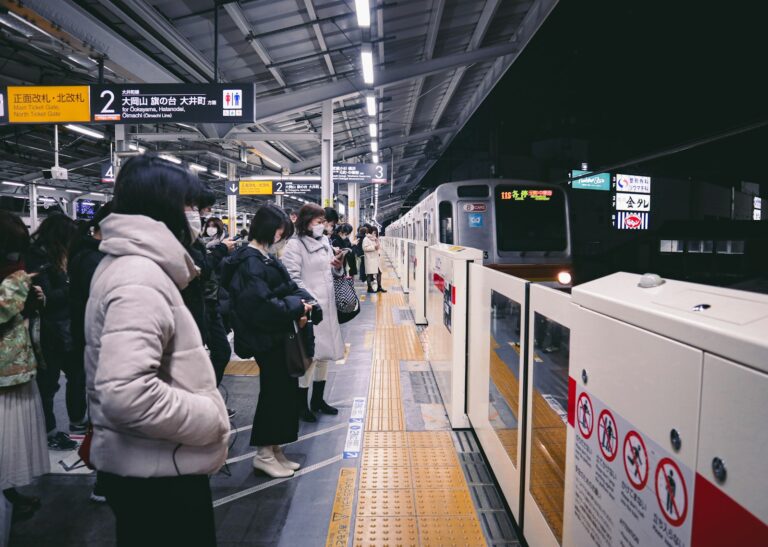 Commuters waiting on a train platform in Japan