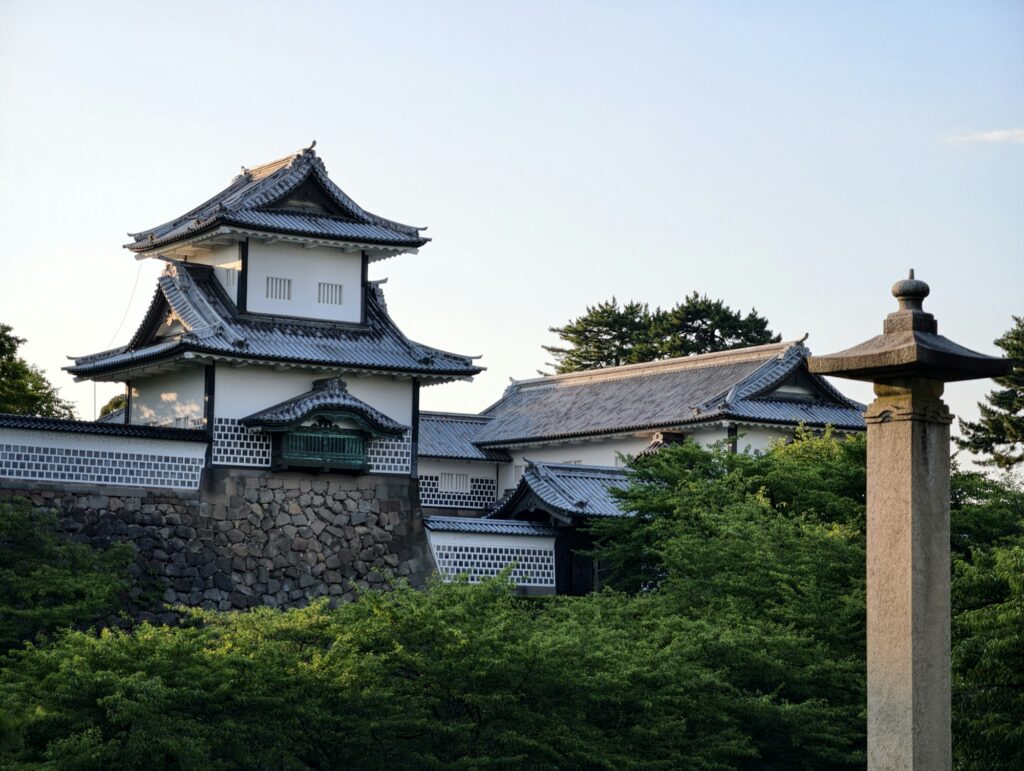 A traditional gate and stone lantern at Kanazawa Castle Park