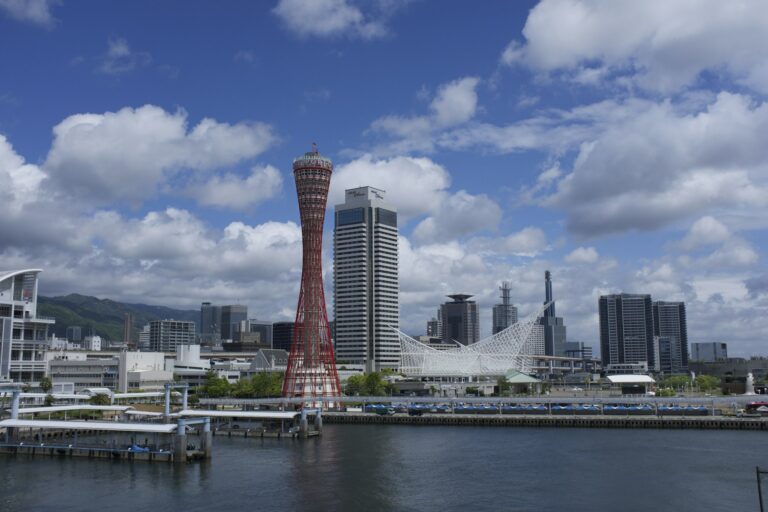 The red Kobe Port Tower and Meriken Park waterfront seen across Kobe harbor