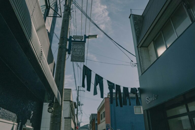 Pairs of jeans hanging on lines above Kojima Jeans Street in Kurashiki