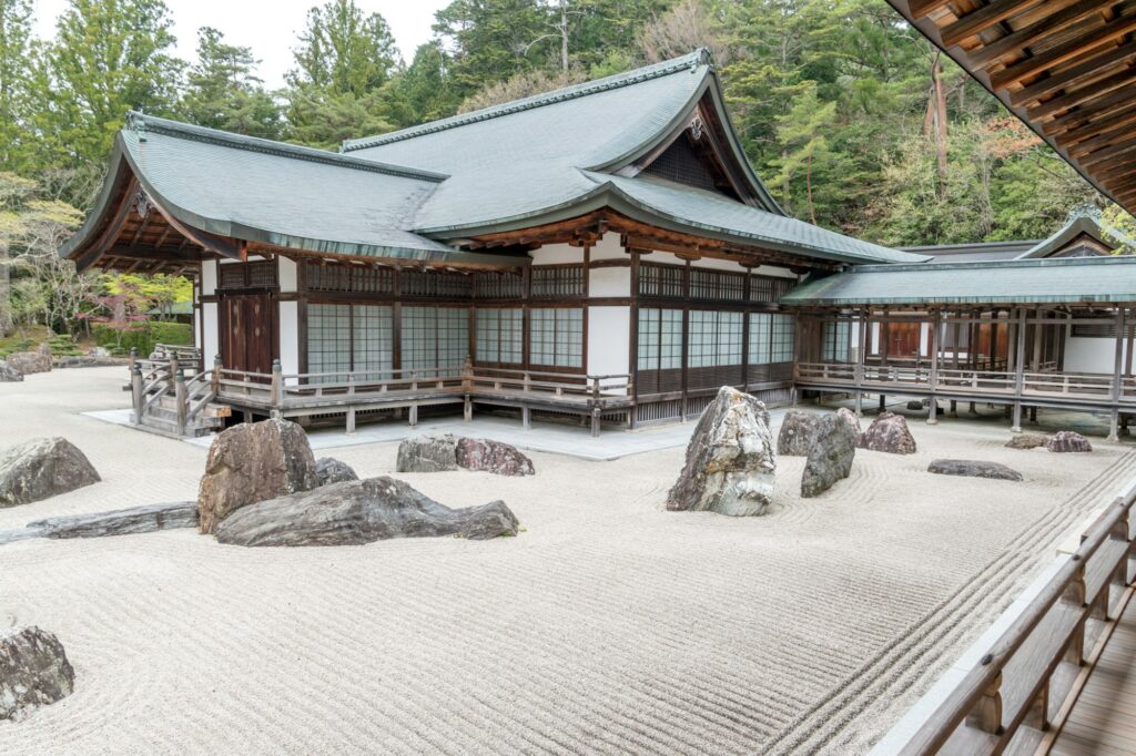 Granite rocks in raked white gravel in front of the halls of Kongobuji Temple on Koyasan