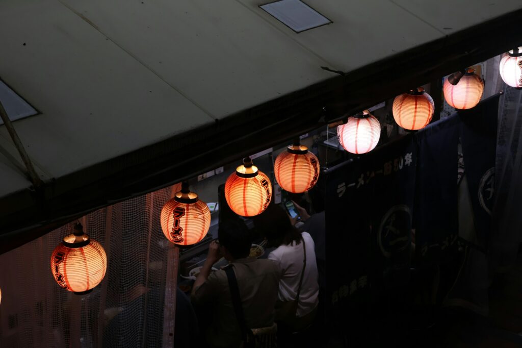 Paper lanterns glowing above visitors in the Achi area of Kurashiki