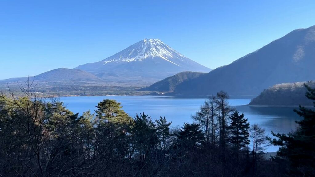 Mount Fuji seen across the blue water of Lake Motosu