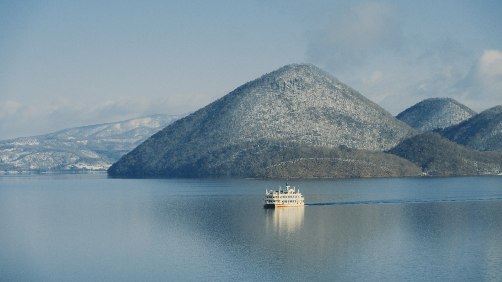 Cruise boat on Lake Toya with Nakajima Island in Hokkaido
