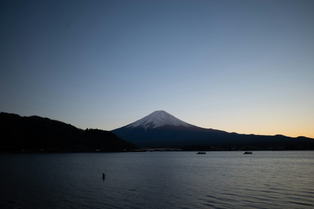 Mount Fuji over calm Lake Yamanaka at dusk