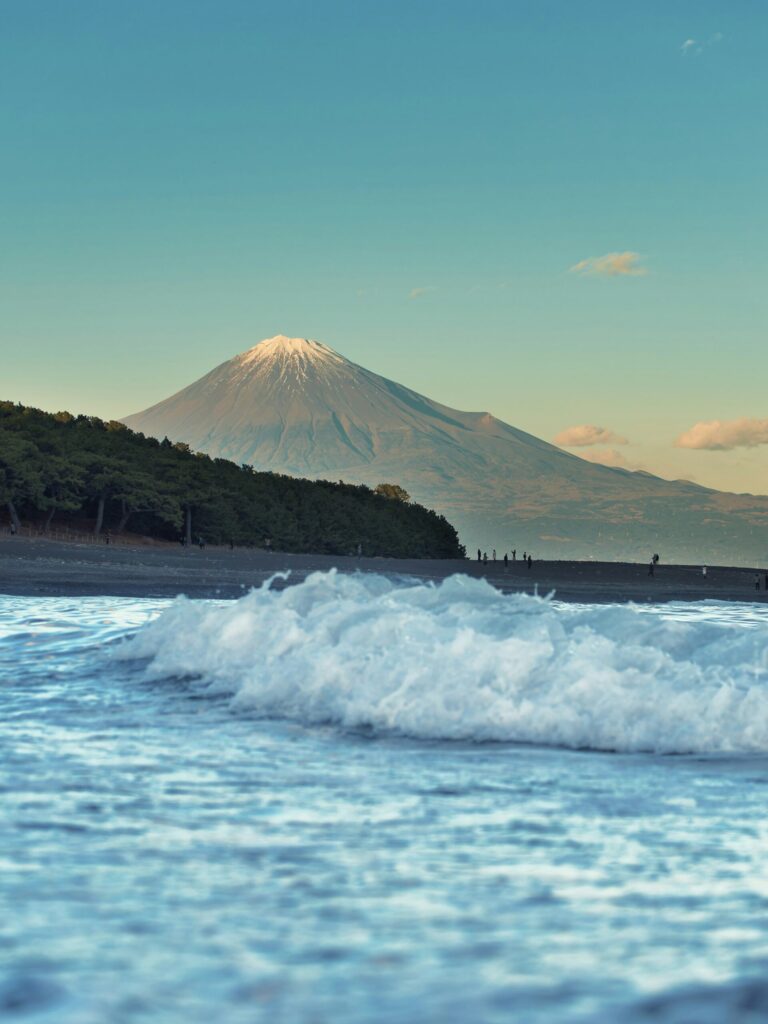 Waves rolling onto the beach at Miho no Matsubara with snow-capped Mount Fuji across Suruga Bay