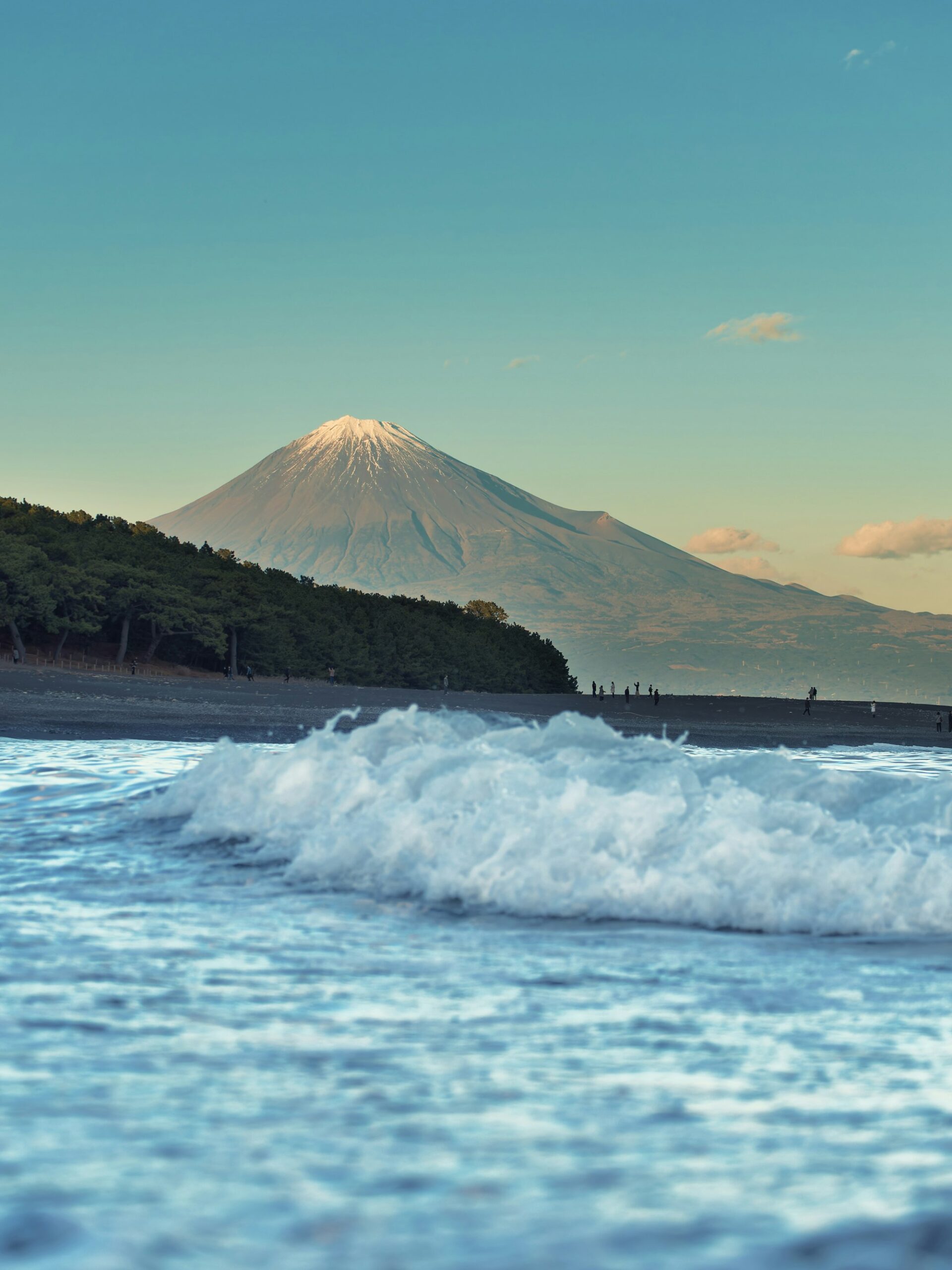 Waves rolling onto the beach at Miho no Matsubara with snow-capped Mount Fuji across Suruga Bay