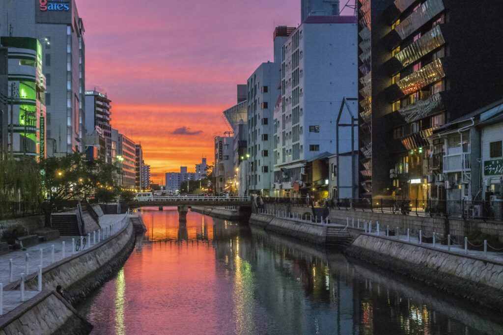 Sunset over the Naka River between the buildings of central Fukuoka