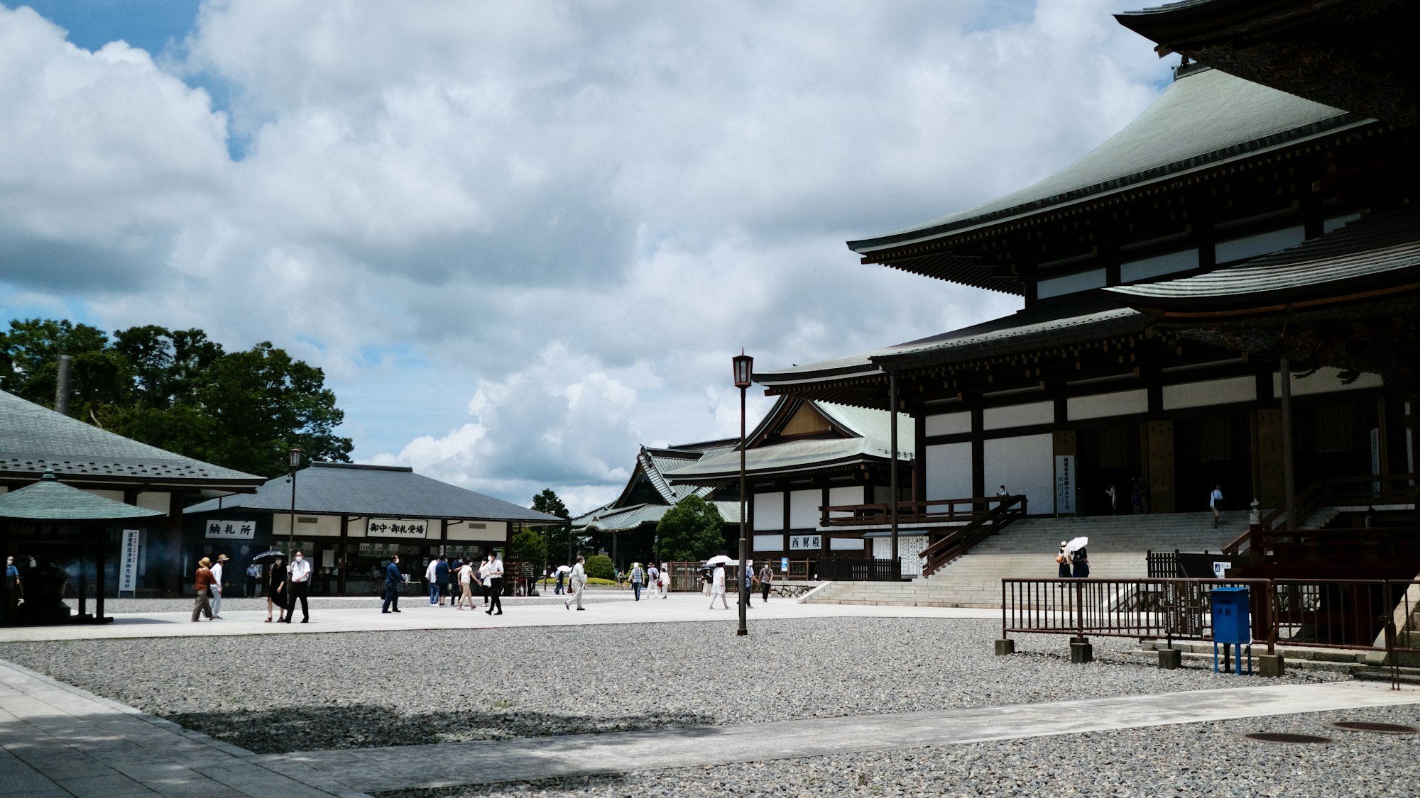 Visitors crossing the grounds of Naritasan Shinsho-ji Temple in Narita