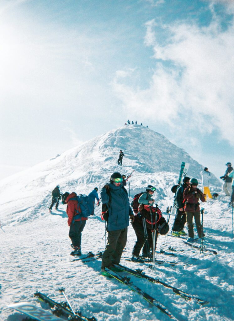 Skiers on a ridge in Niseko. Check whether your policy covers terrain beyond the resort ropes.