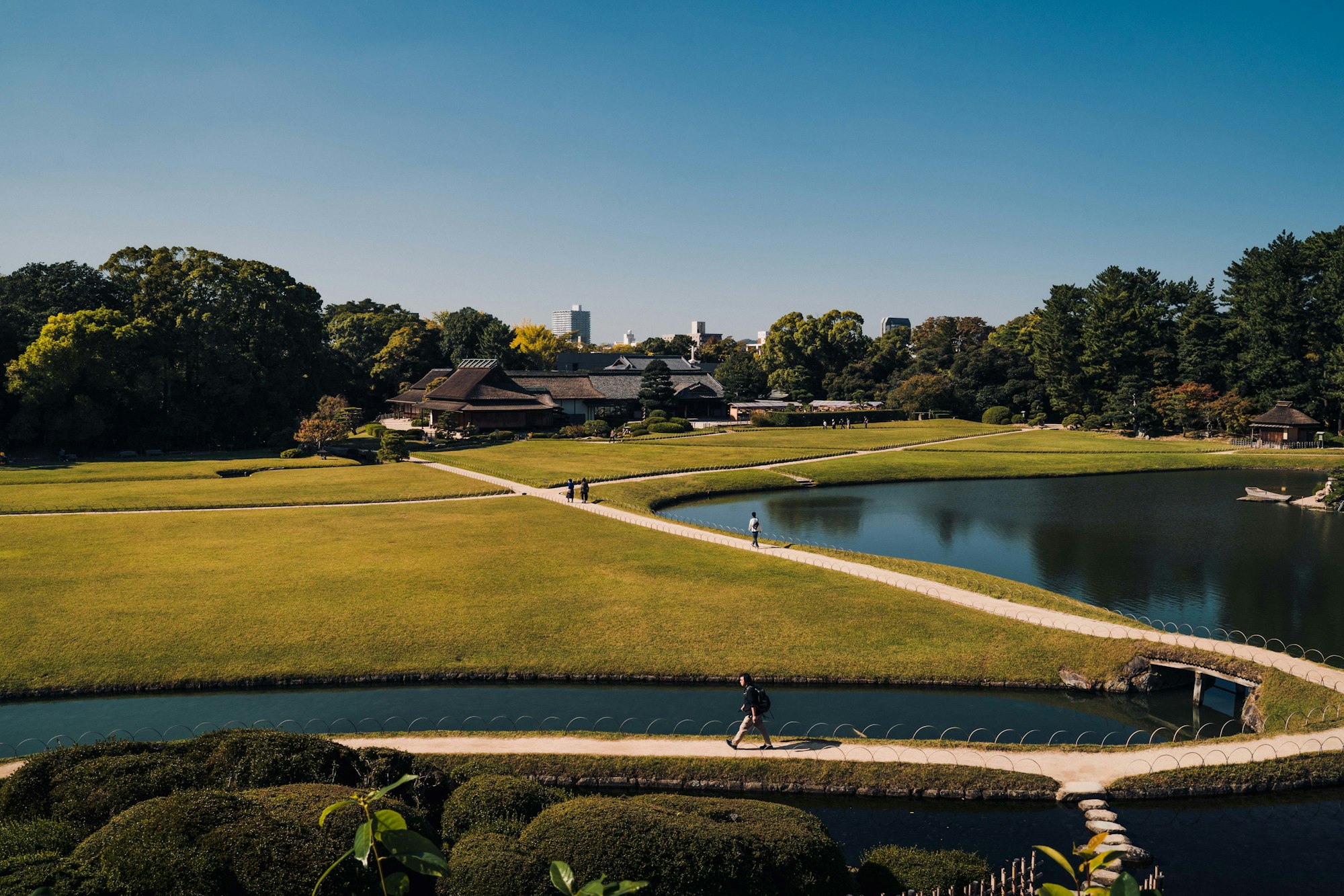 Broad lawns, a pond and a winding path at Okayama Korakuen Garden