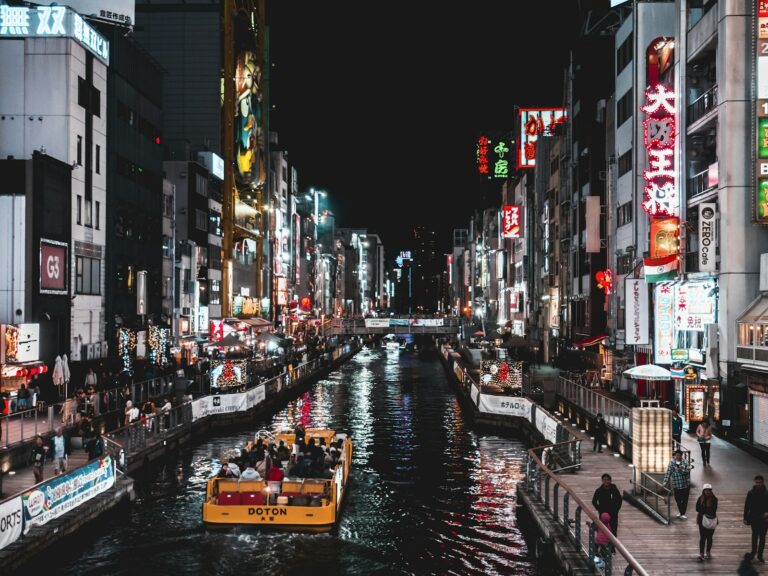 Neon signs reflected in the Dotonbori canal at night in Namba, Osaka