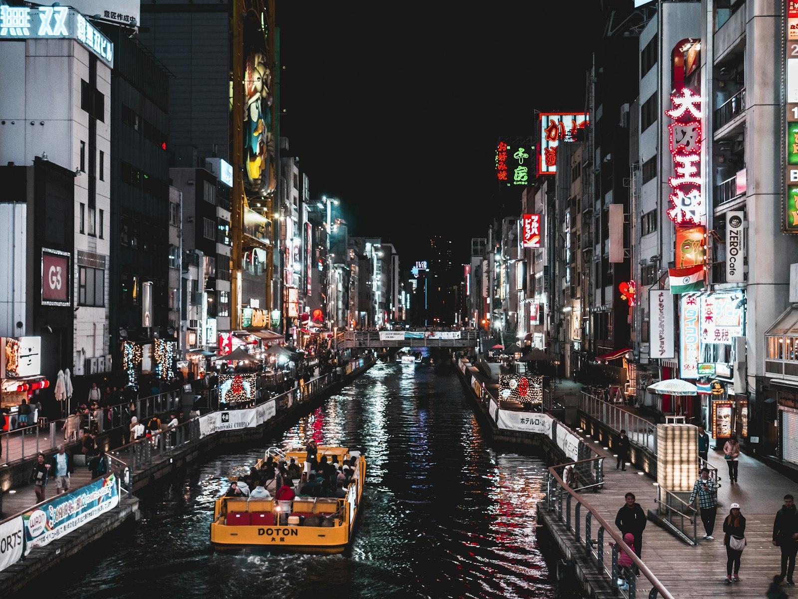 Neon signs reflected in the Dotonbori canal at night in Namba, Osaka