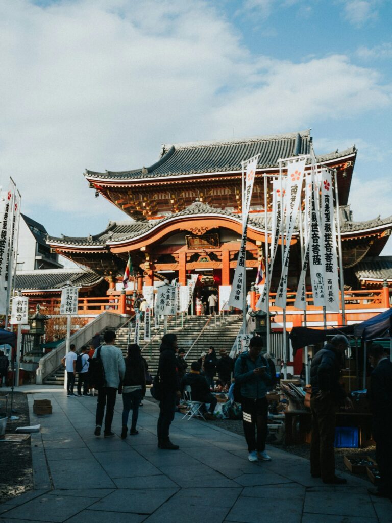 Visitors on the steps of the red main hall of Osu Kannon temple in Nagoya