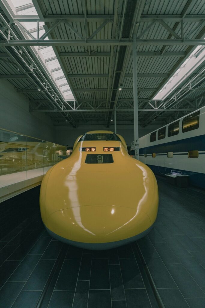 The yellow Doctor Yellow Shinkansen inspection train on display at the SCMaglev and Railway Park
