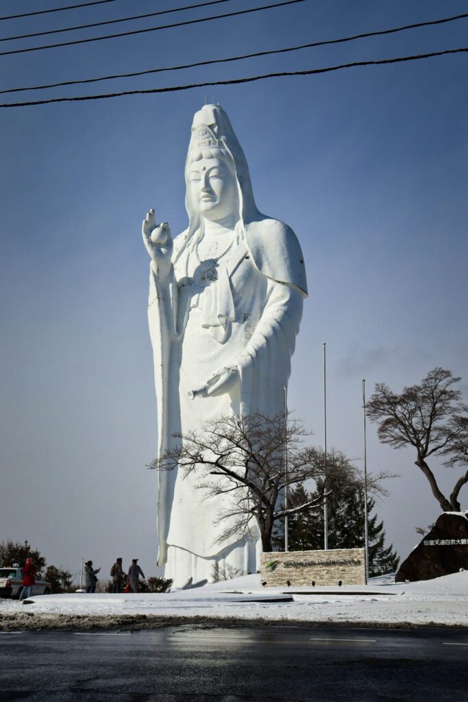 The white Sendai Daikannon statue towering over the city