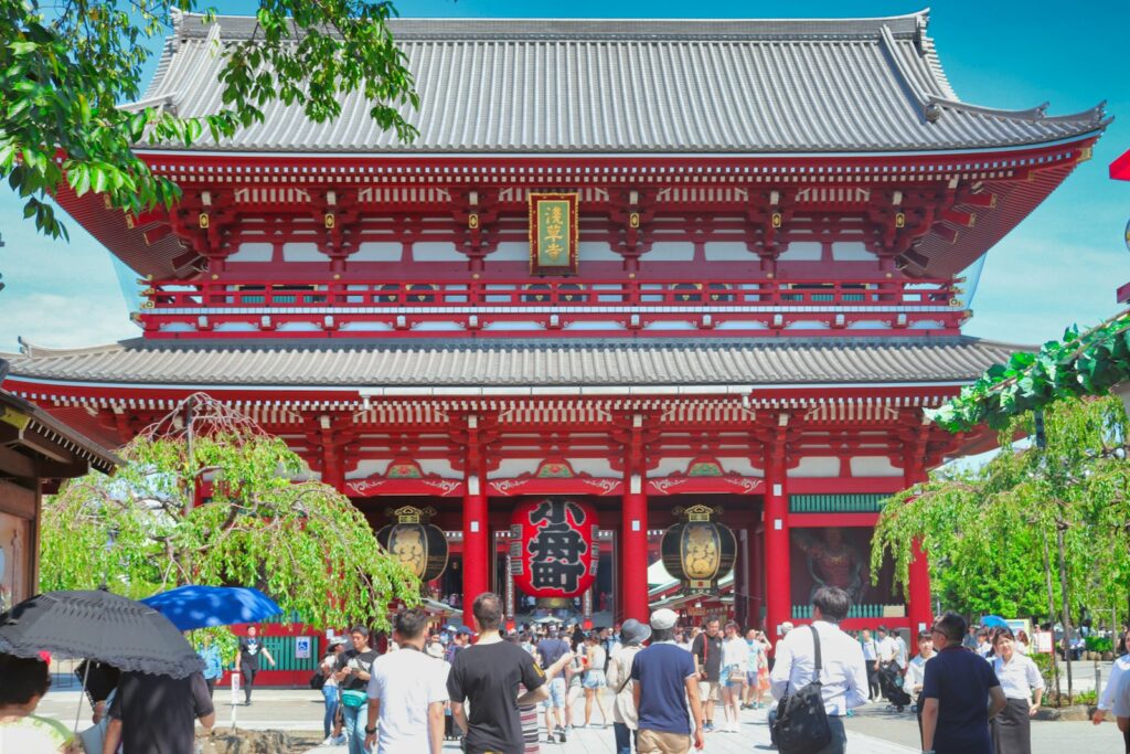 Visitors walking toward a large red gate at Senso-ji Temple in Asakusa