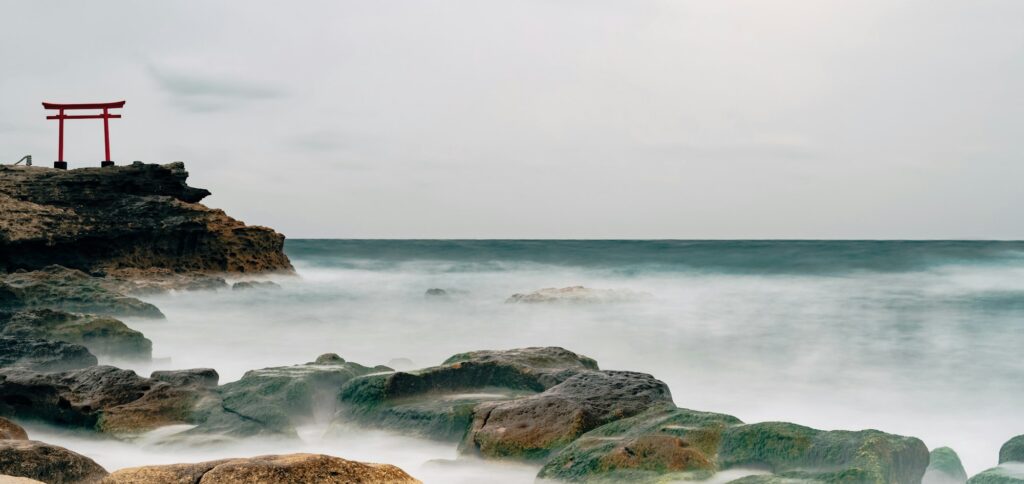 Waves washing over dark rocks on the coast of Shimoda