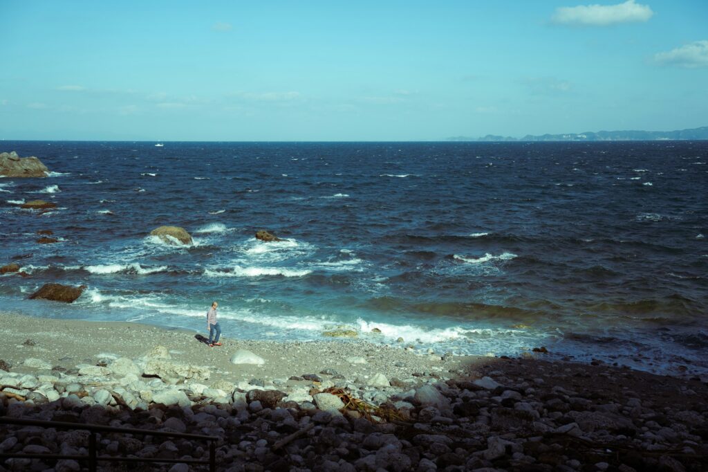 Waves washing onto the rocky edge of Shirahama Beach in Shimoda