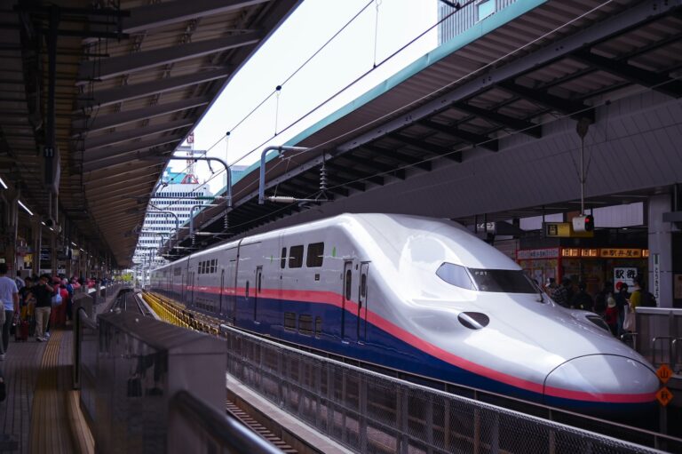 Shinkansen bullet train arriving at a platform