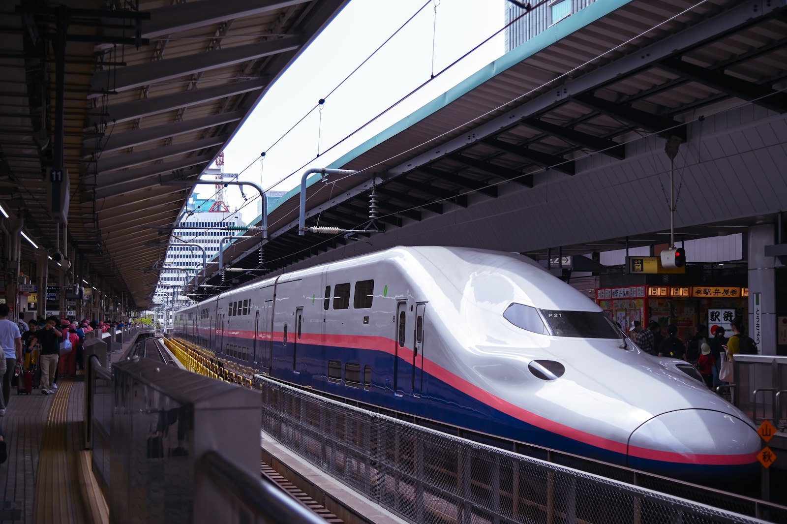 Shinkansen bullet train arriving at a platform