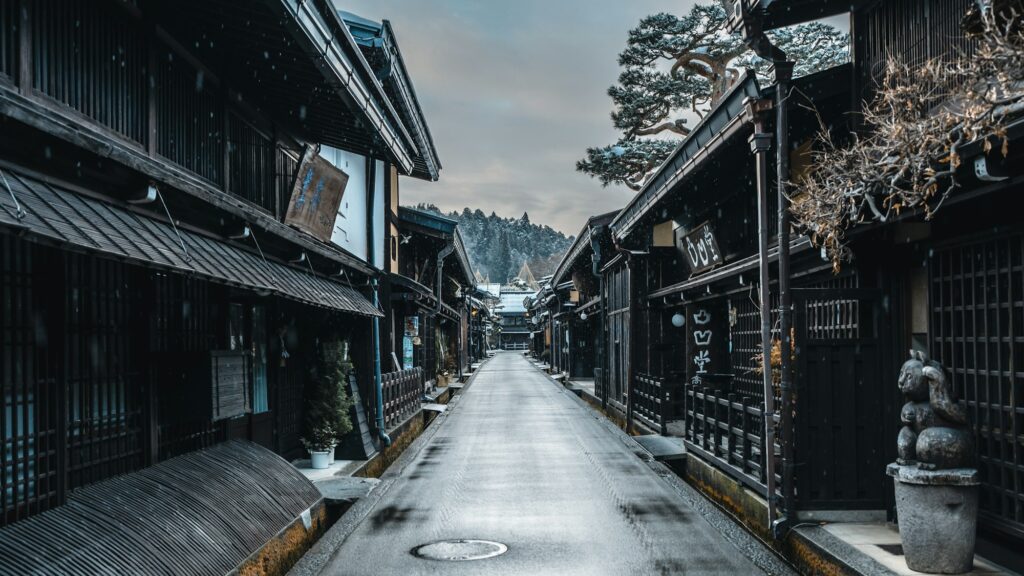Dark wooden merchant houses lining a street in Takayama old town