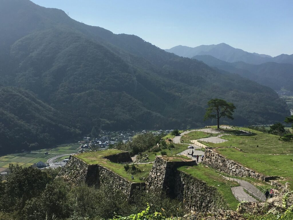 The stone walls of Takeda Castle Ruins along a mountain ridge above the valley in Asago, Hyogo