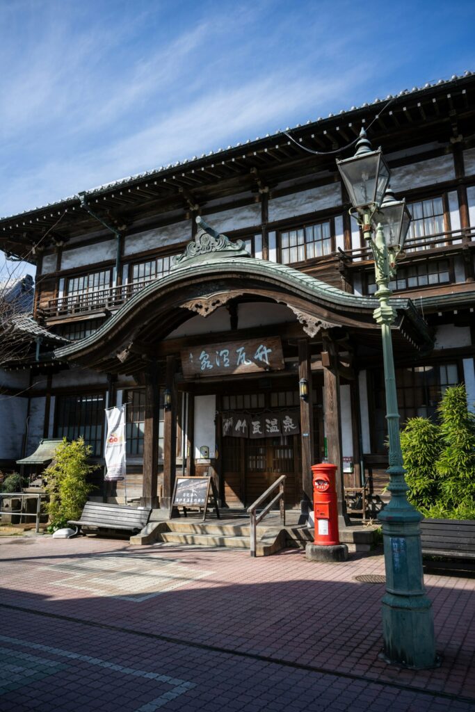 The curved wooden gable entrance of Takegawara Onsen in Beppu