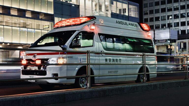 A Tokyo Fire Department ambulance on a street in Shinjuku at night.