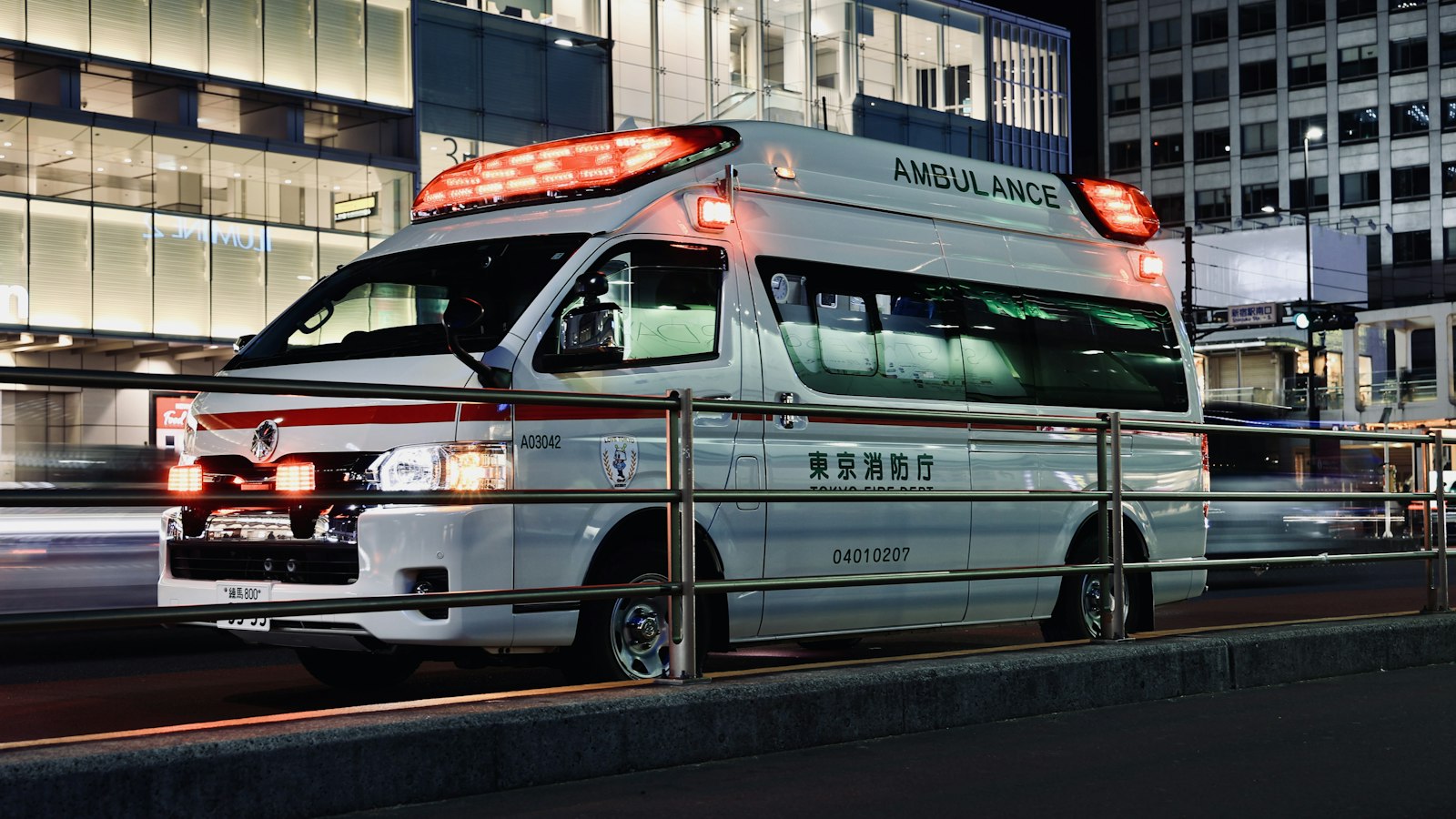 A Tokyo Fire Department ambulance on a street in Shinjuku at night.