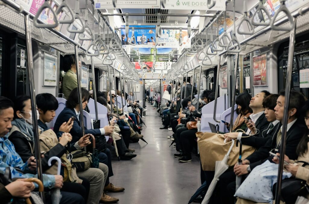 Phones out on a Tokyo train: most travelers hop between several Wi-Fi networks a day in Japan.
